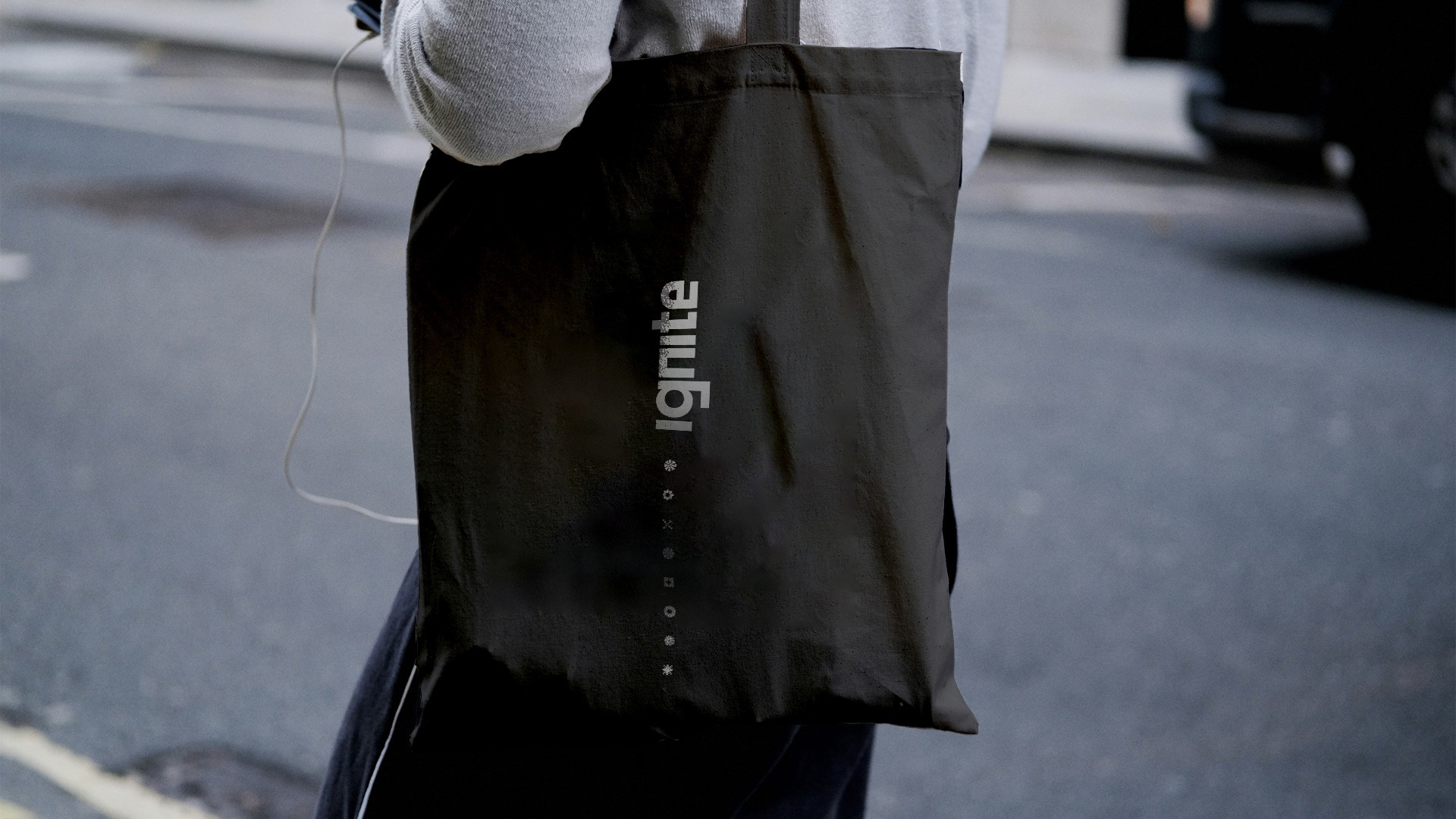 Graphic of a typography specimen showing the alphabet and numerals on top of a dark gray background.